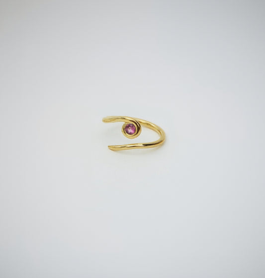 Gold ring with a pink gemstone on a white background