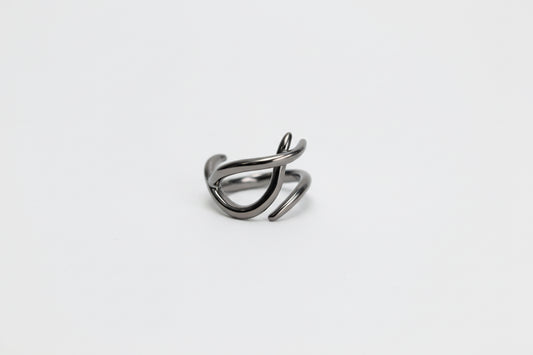 Silver ring with a unique design on a light gray background